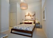 Thumbnail 28 of 31 - a bedroom with a bed and a painting on the wall