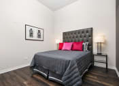 Thumbnail 24 of 31 - a bedroom with a bed with red pillows