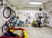Thumbnail 30 of 31 - a group of bikes hanging on a wall in a garage