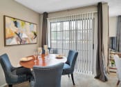 Thumbnail 46 of 77 - a dining room with a table and chairs and a window