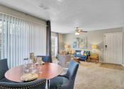 Thumbnail 47 of 77 - a dining room with a table and chairs and a living room