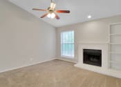 Thumbnail 55 of 77 - a living room with a fireplace and a ceiling fan