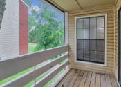 Thumbnail 54 of 77 - a porch with a large window and a wooden deck