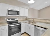 Thumbnail 70 of 77 - a kitchen with stainless steel appliances and white cabinets