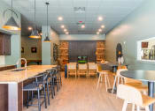 Thumbnail 4 of 19 - a dining room with tables and chairs and a bar with chairs