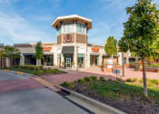 Thumbnail 1 of 19 - the exterior of a store with a clock on the front of it