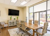 Thumbnail 10 of 19 - a conference room with a table and chairs and a television