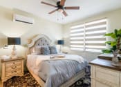 Thumbnail 15 of 19 - a bedroom with a bed and a ceiling fan