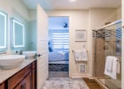 Thumbnail 17 of 19 - a bathroom with a shower and a sink and a mirror