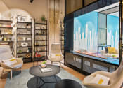 Thumbnail 9 of 31 - a living room with chairs and a large television
