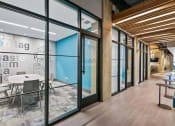 Thumbnail 20 of 31 - a conference room with glass doors and a table and chairs