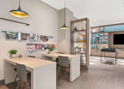 Thumbnail 29 of 31 - a dining area with tables and chairs and a tv