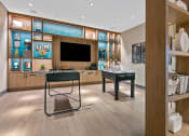 Thumbnail 26 of 31 - a room with a desk and a television in it