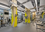 Thumbnail 13 of 31 - a gym with weights and other exercise equipment in a building with windows