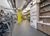 Thumbnail 12 of 31 - a room filled with cardio equipment and chairs in a gym