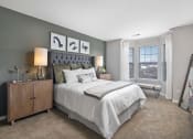 Thumbnail 3 of 37 - Furnished model bedroom with a queen sized bed and oversized bay windows