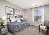 Thumbnail 6 of 37 - Furnished model bedroom with office desk and golf course view from the oversized bay windows
