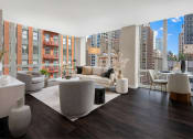 Thumbnail 9 of 28 - a living room with couches and chairs and a large window