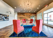 Thumbnail 5 of 39 - a lounge area with chairs and a table and a chandelier