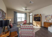 Thumbnail 16 of 39 - a living room with a couch and a tv