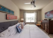 Thumbnail 19 of 39 - a bedroom with a large bed and a ceiling fan