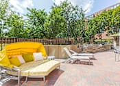 Thumbnail 7 of 34 - A yellow couch with a yellow cushion is on a patio.