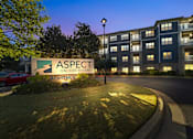Thumbnail 1 of 30 - A sign for Aspect on the River Apartments is shown in front of a building.