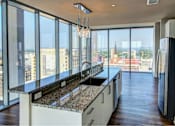 Thumbnail 3 of 18 - A kitchen with a view of the cityscape.