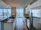 Thumbnail 5 of 18 - A modern kitchen with a view of the city.