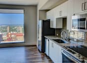 Thumbnail 9 of 18 - A kitchen with a view of the city.