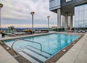 Thumbnail 17 of 18 - A large indoor swimming pool with a view of the city.