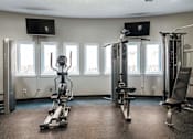 Thumbnail 20 of 41 - a gym with weights and a row of windows