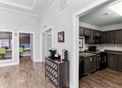 Thumbnail 14 of 23 - A kitchen with dark wood cabinets and a black and white patterned refrigerator.