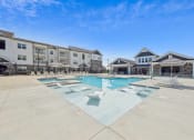 Thumbnail 4 of 20 - a swimming pool with apartment buildings in the background