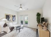 Thumbnail 9 of 20 - a living room with a white couch and a ceiling fan