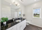 Thumbnail 11 of 20 - a white bathroom with a sink and a toilet