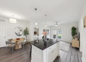 Thumbnail 14 of 20 - a white kitchen with a black counter top in a house