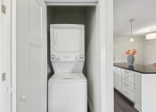 Thumbnail 20 of 20 - a white washer and dryer in a white laundry room
