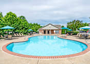 Thumbnail 9 of 23 - A large outdoor swimming pool surrounded by a brick border.