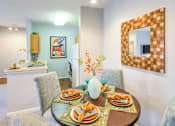 Thumbnail 18 of 23 - A dining room with a table set for a meal.