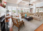 Thumbnail 25 of 28 - A living room with a fireplace and a chair.
