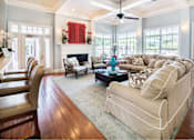 Thumbnail 28 of 28 - A living room with a fireplace and a couch.