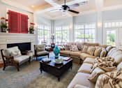 Thumbnail 27 of 28 - A living room with a fireplace and a couch.