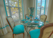 Thumbnail 8 of 28 - A table with a vase and books on it.