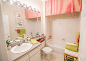 Thumbnail 12 of 28 - A bathroom with a sink, toilet, and bathtub.