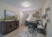 Thumbnail 1 of 40 - A dining room with a wooden table and chairs.
