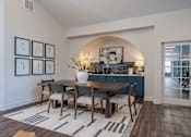 Thumbnail 17 of 40 - A dining room with a table set for four.