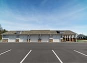 Thumbnail 61 of 64 - A large building with a parking lot in front.