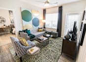 Thumbnail 9 of 64 - A living room with a grey sofa and a patterned rug.