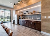 Thumbnail 5 of 26 - A modern kitchen with wooden cabinets and a large island.